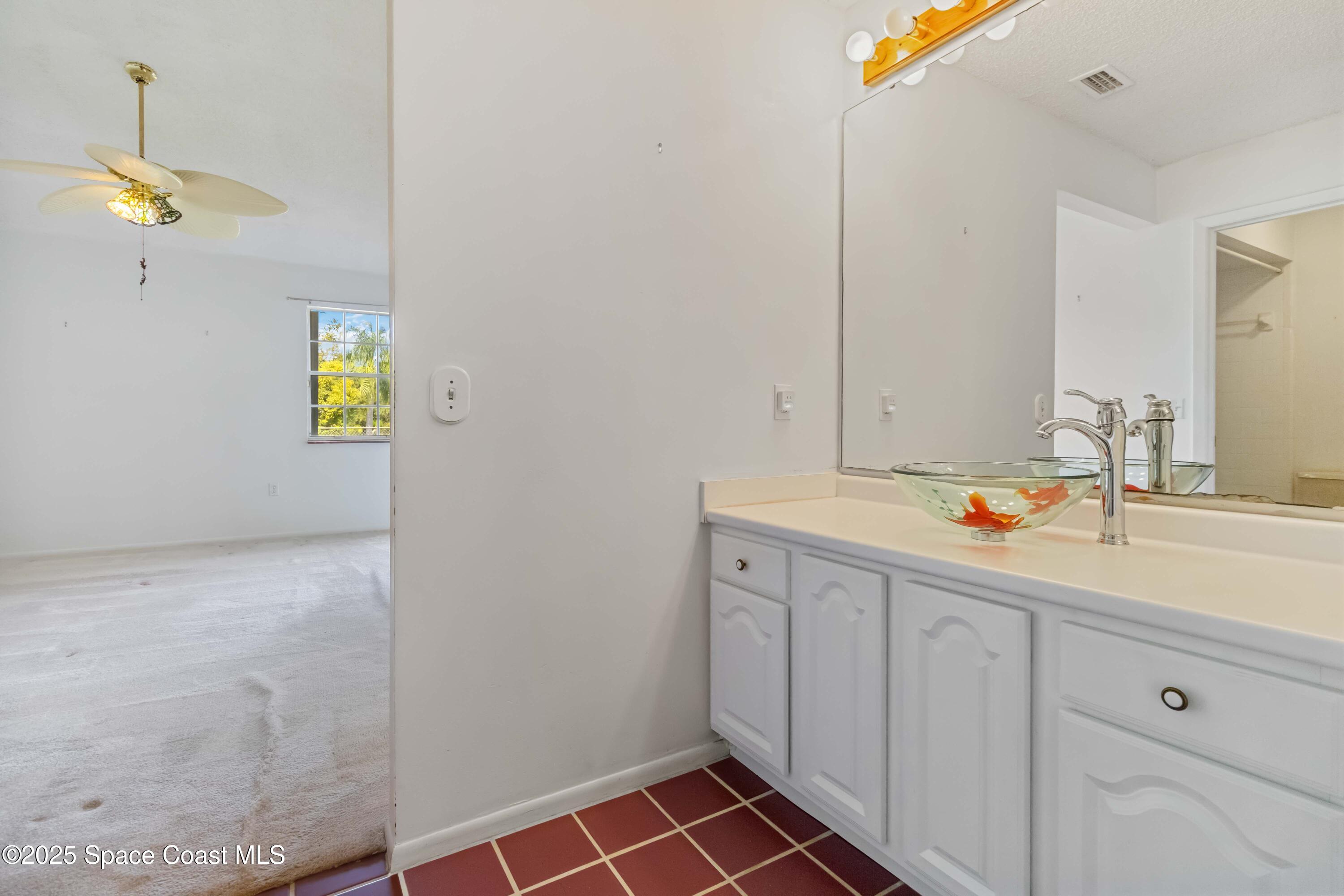 3728 West Malory Court Cocoa, FL 32926 - Photo 27 of 37 a bathroom with a sink and a mirror