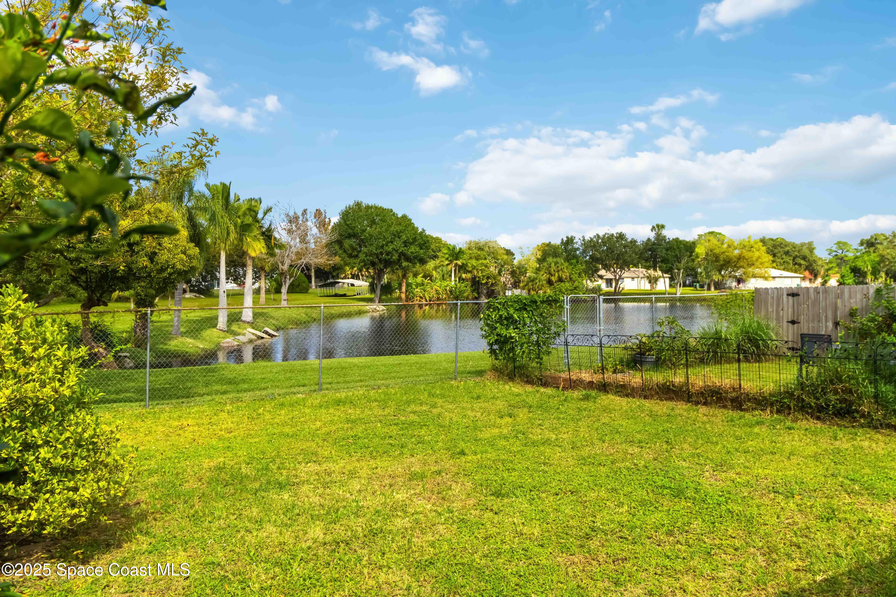 3728 West Malory Court Cocoa, FL 32926 - Photo 32 of 37 a view of a lake with houses in the background