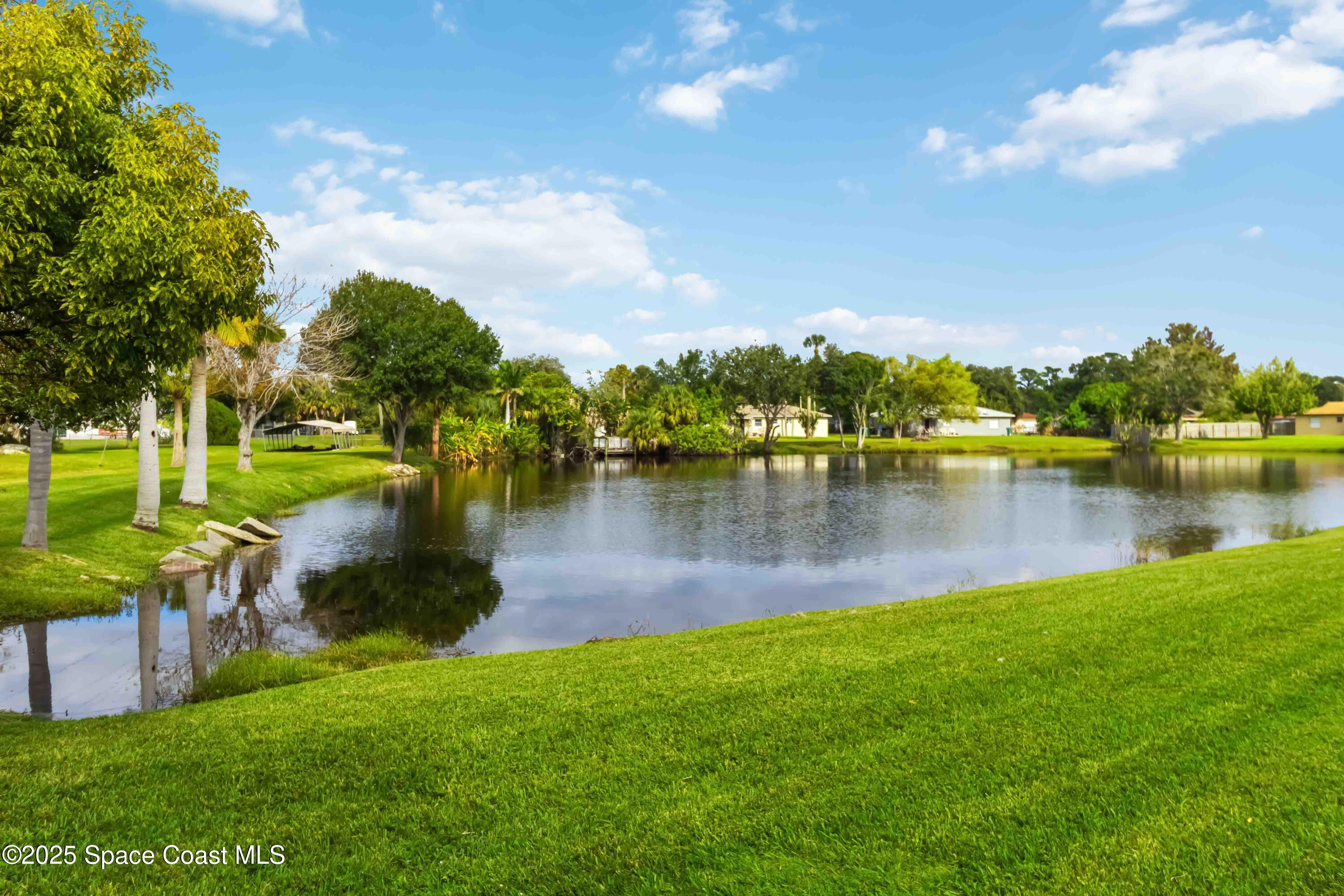 3728 West Malory Court Cocoa, FL 32926 - Photo 34 of 37 a view of a lake with houses in the back