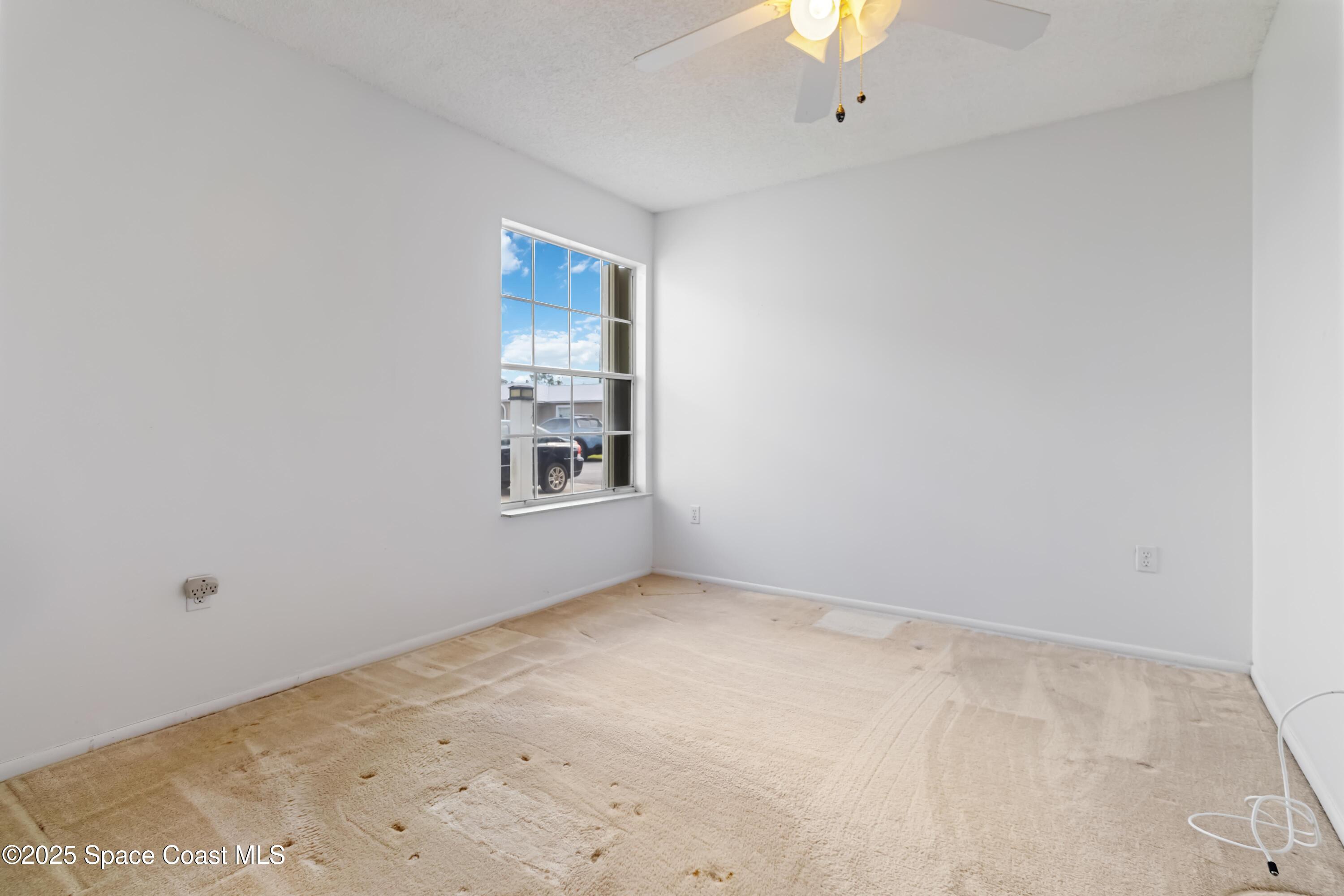 3728 West Malory Court Cocoa, FL 32926 - Photo 4 of 17 an empty room with windows