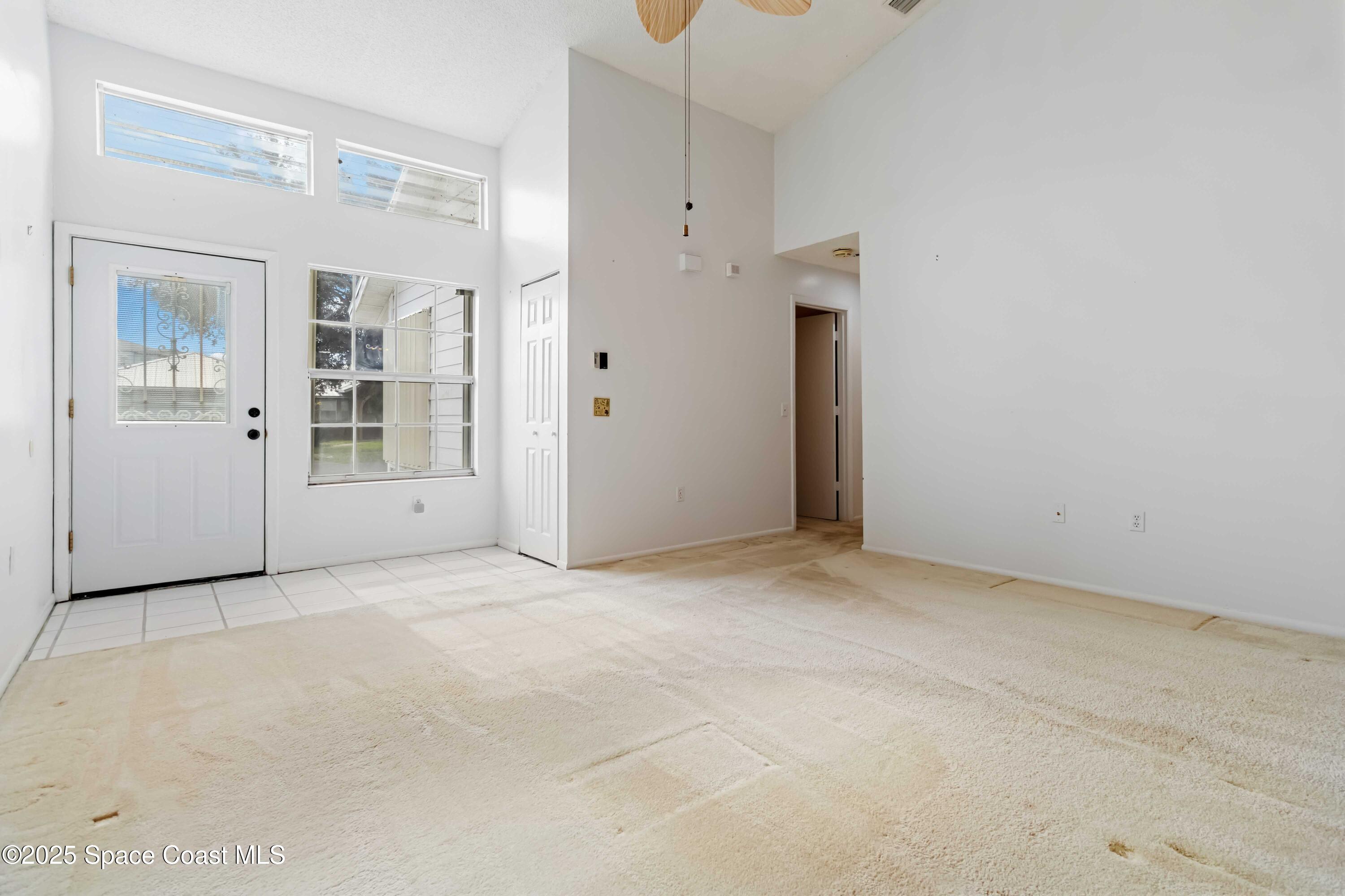 3728 West Malory Court Cocoa, FL 32926 - Photo 7 of 37 an empty room with entrance and windows