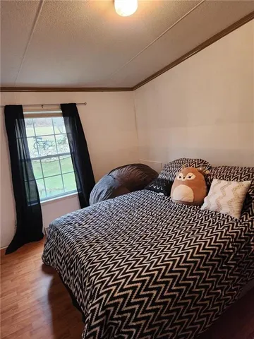 a bedroom with a bed and window