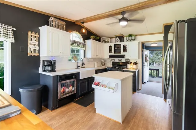 a kitchen with a stove a refrigerator and a sink