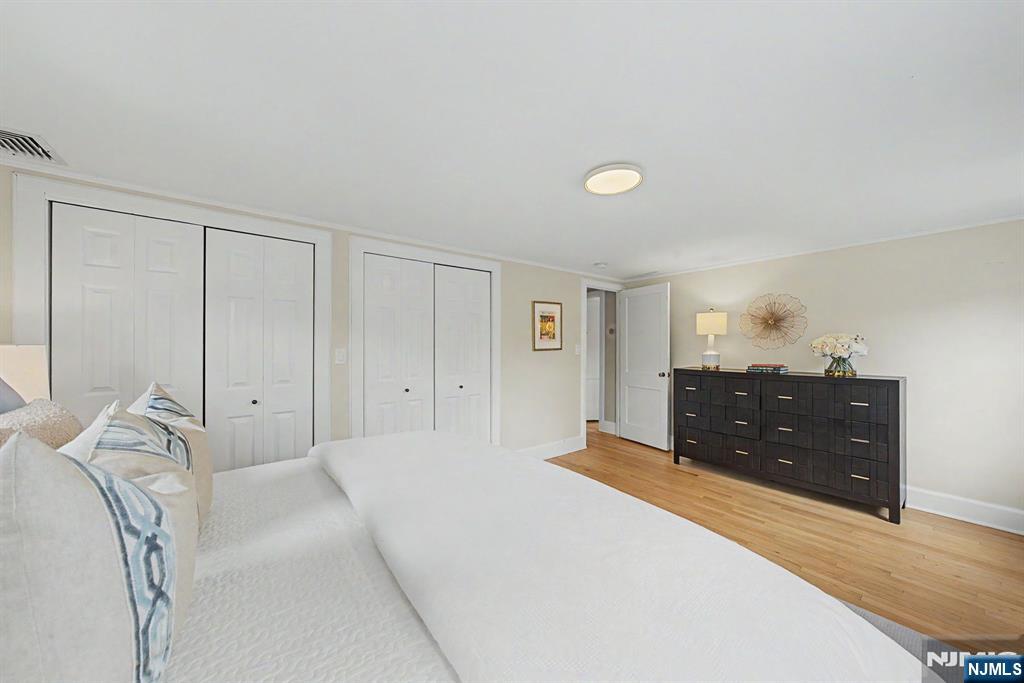 45 Highfield Road Bloomfield, NJ 07003 - Photo 27 of 50 a spacious bedroom with a bed and a lamp
