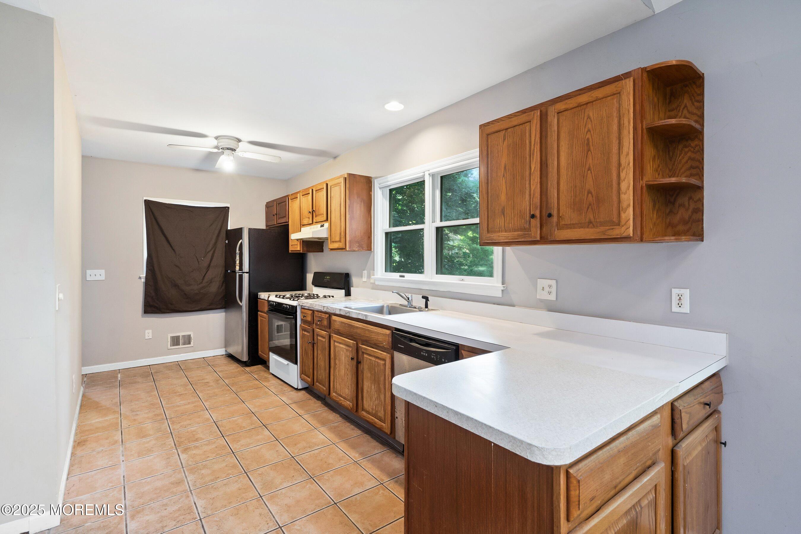 2148 Allenwood Road Wall, NJ 07719 - Photo 6 of 27 a kitchen with stainless steel appliances granite countertop a sink and a stove