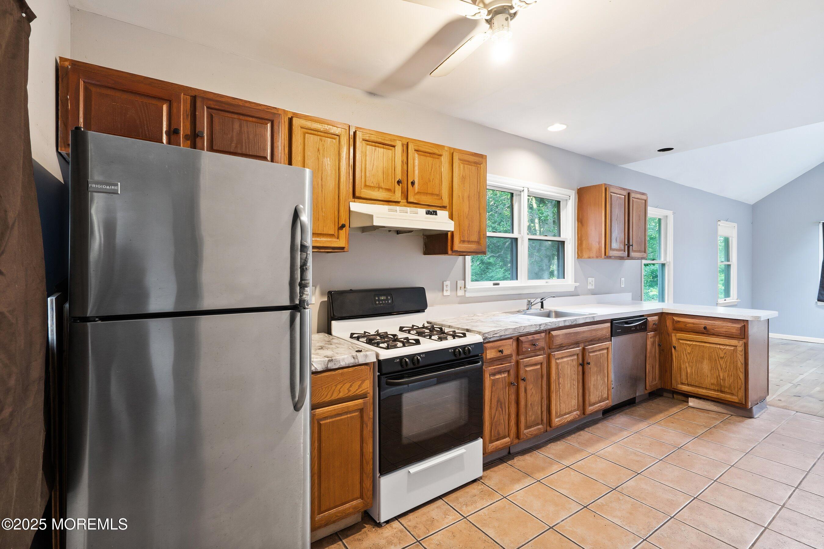 2148 Allenwood Road Wall, NJ 07719 - Photo 7 of 27 a kitchen with granite countertop a refrigerator stove top oven and sink