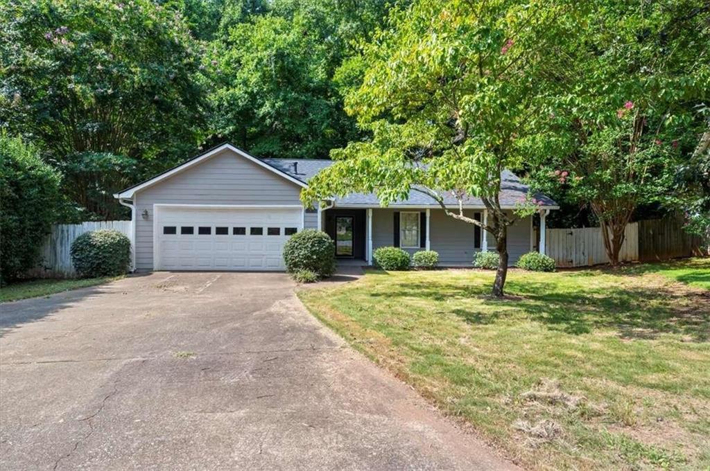 11250 Ridge Hill Drive Alpharetta, GA 30022 - Photo 1 of 1 a house with a tree in front of it