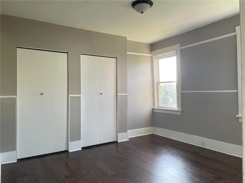 732 Bay Ridge Avenue, Unit 2 Brookline, PA 15226 - Photo 2 of 9 an empty room with wooden floor cabinet and windows