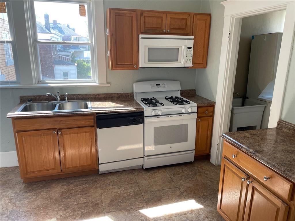 732 Bay Ridge Avenue, Unit 2 Brookline, PA 15226 - Photo 8 of 9 a kitchen with a stove microwave and sink