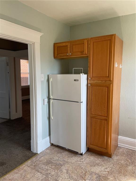 732 Bay Ridge Avenue, Unit 2 Brookline, PA 15226 - Photo 9 of 9 a view of a refrigerator in kitchen and white cabinets