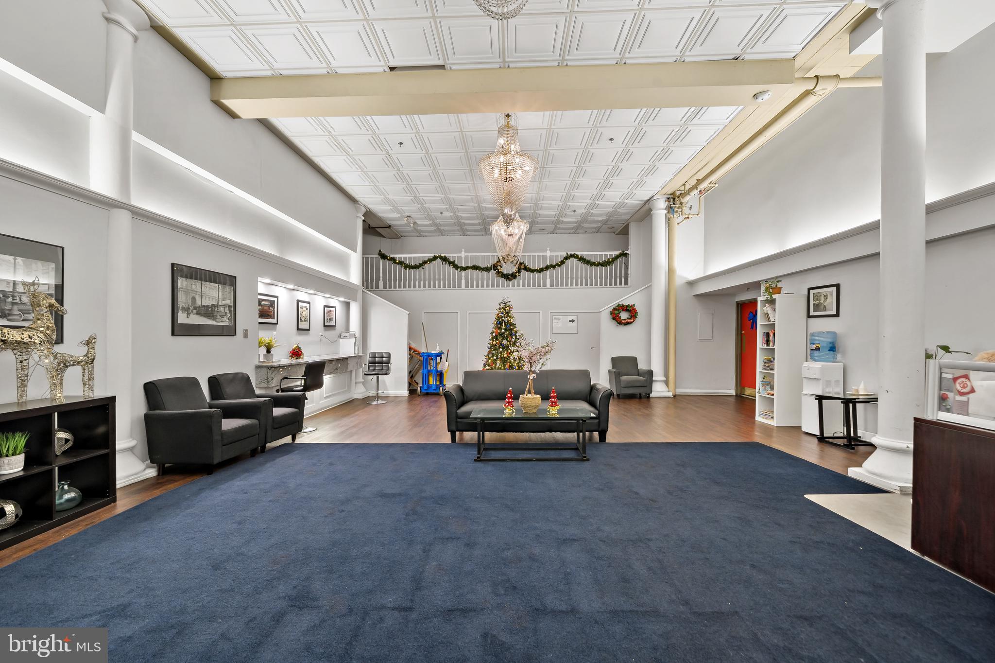 1010 Race Street, Unit PG Philadelphia, PA 19107 - Photo 12 of 14 a living room with furniture and a chandelier
