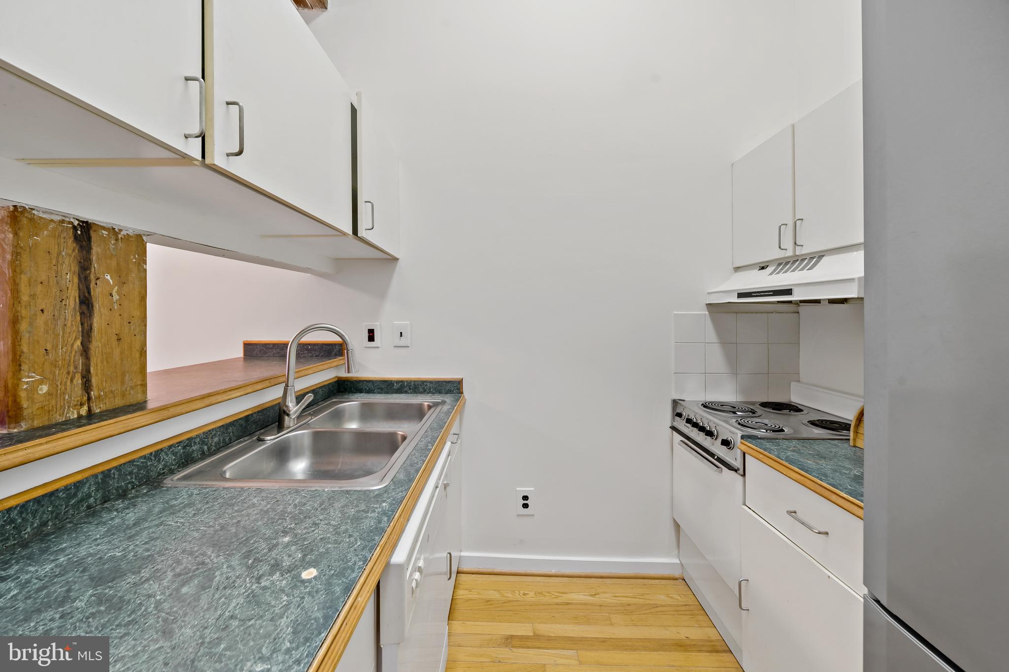 1010 Race Street, Unit PG Philadelphia, PA 19107 - Photo 6 of 14 a kitchen that has a sink and a stove