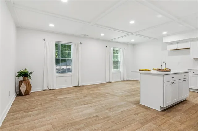 a view of a kitchen with wooden floor and a sink