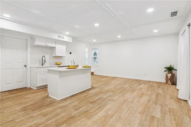 a view of a hallway with wooden floor and windows