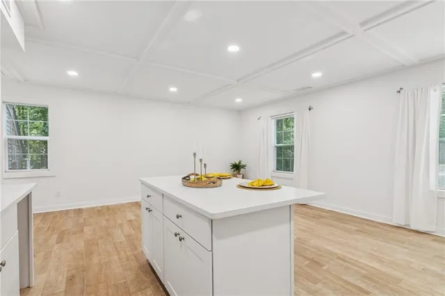 an empty room with wooden floor and ceiling fan