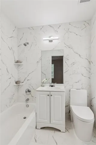 a view of an empty room with wooden floor and stairs
