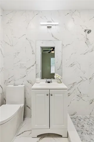 a kitchen with granite countertop white cabinets and sink