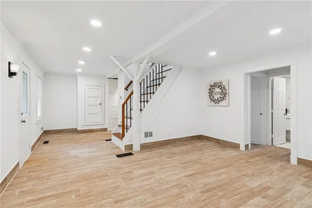 a bathroom with a granite countertop sink and a toilet