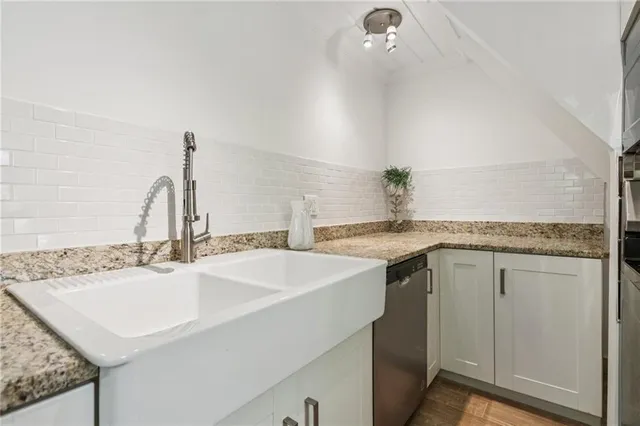 a view of a lush green forest with a house in the background