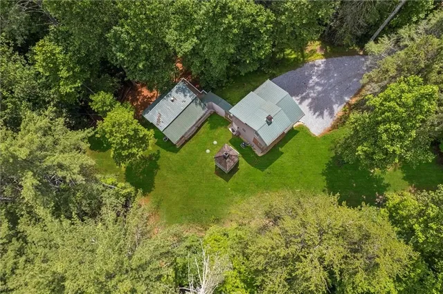 an aerial view of a house with a garden and deck