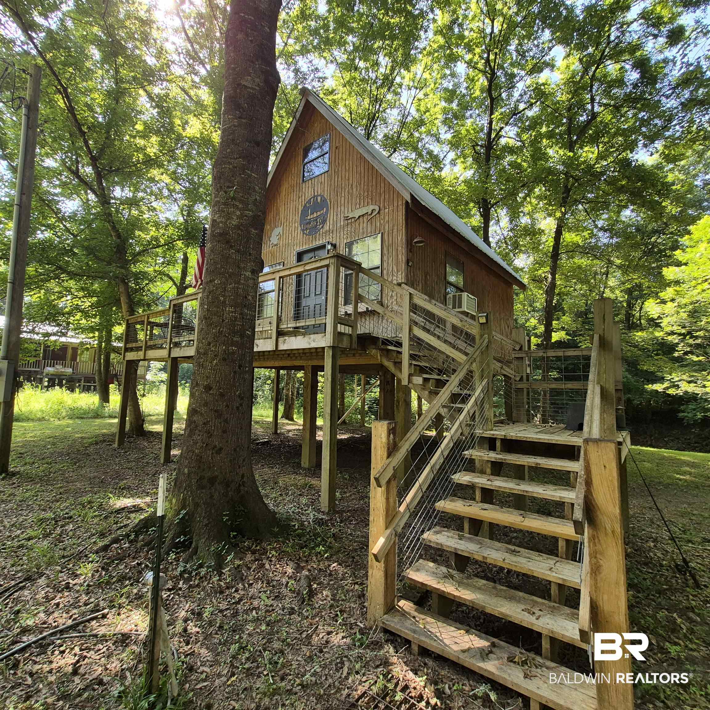 0 Eureka Landing Road Uriah, AL 36480 - Photo 17 of 27 Elevated wood-sided residence featuring a gabled roof and multiple windows