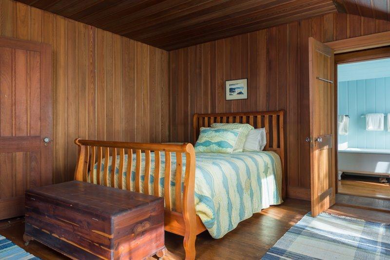 101 Associates Road Falmouth, MA 02540 - Photo 16 of 31 a bedroom with a bed and wooden floor
