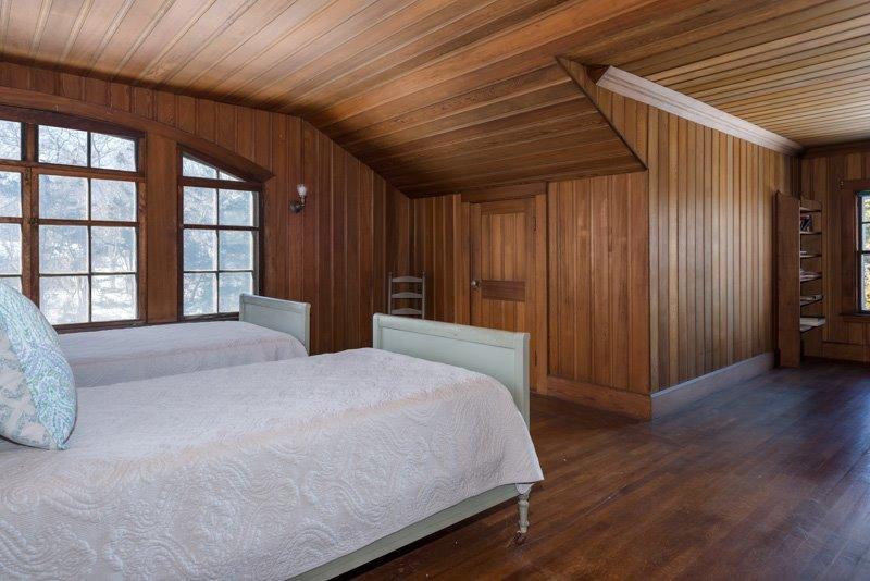 101 Associates Road Falmouth, MA 02540 - Photo 19 of 31 a spacious bedroom with a large bed and wooden floor