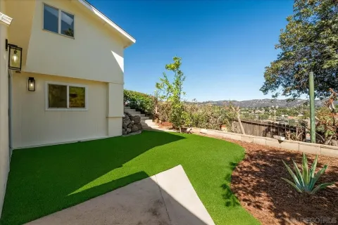 a view of a backyard with plants and lake view