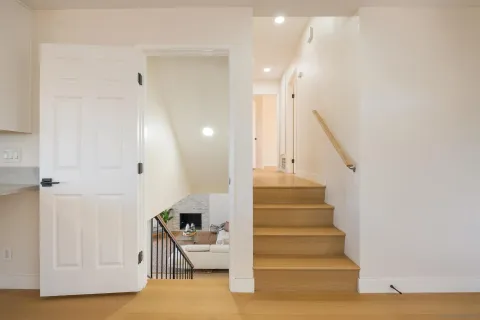 a view of entryway and hall with wooden floor