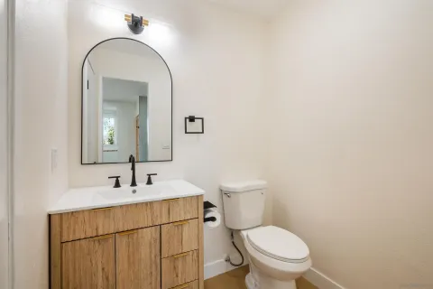 a bathroom with a toilet sink and mirror