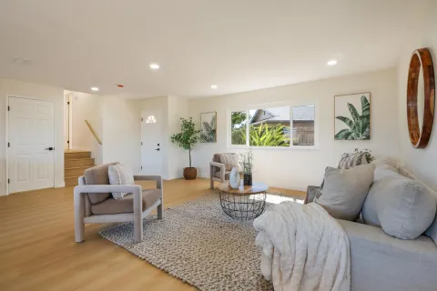 a living room with furniture and wooden floor
