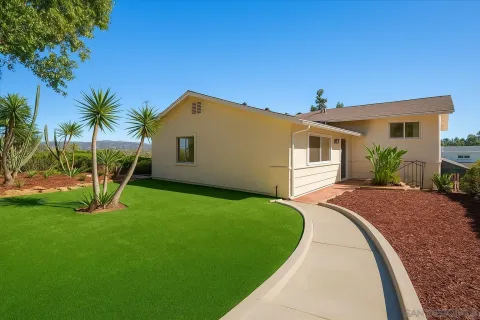 a view of a house with a yard