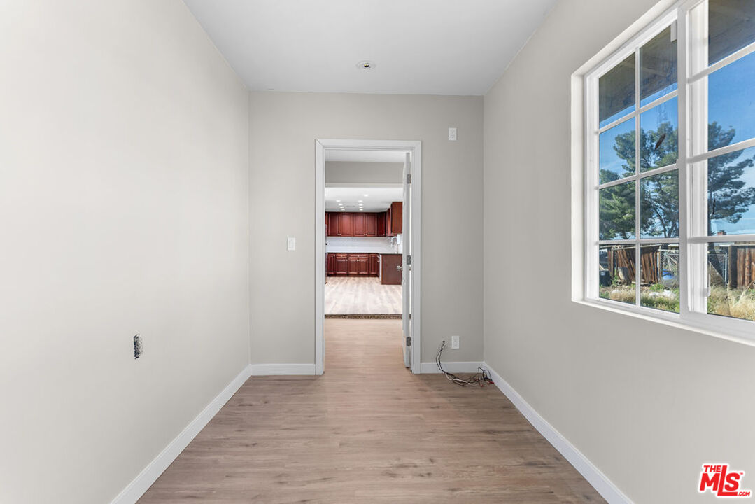 16030 Osage Road Apple Valley, CA 92307 - Photo 14 of 27 an empty room with wooden floor and windows