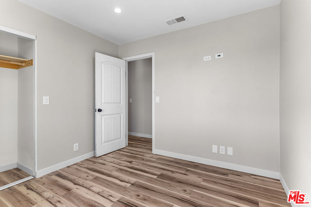 16030 Osage Road Apple Valley, CA 92307 - Photo 18 of 27 a view of a room with wooden floor and closet