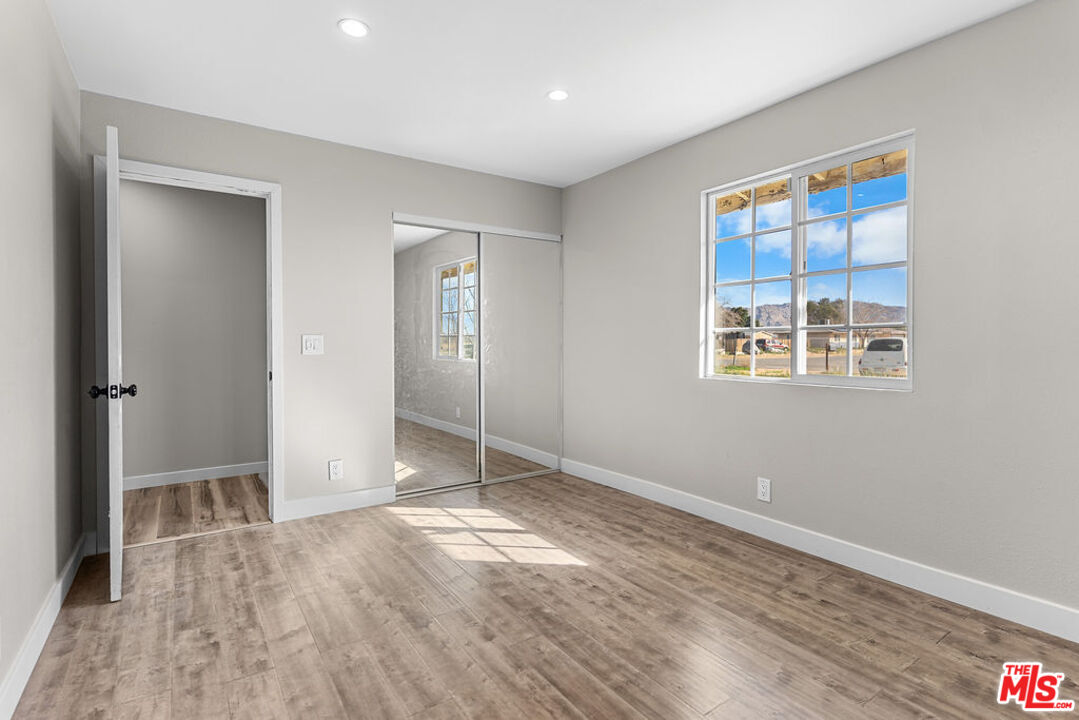 16030 Osage Road Apple Valley, CA 92307 - Photo 19 of 27 wooden floor in an empty room with a window