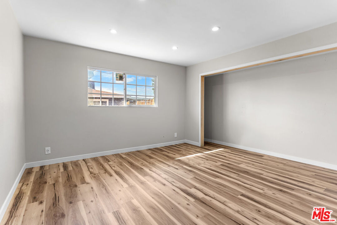 16030 Osage Road Apple Valley, CA 92307 - Photo 20 of 27 a view of room with window and hardwood floor