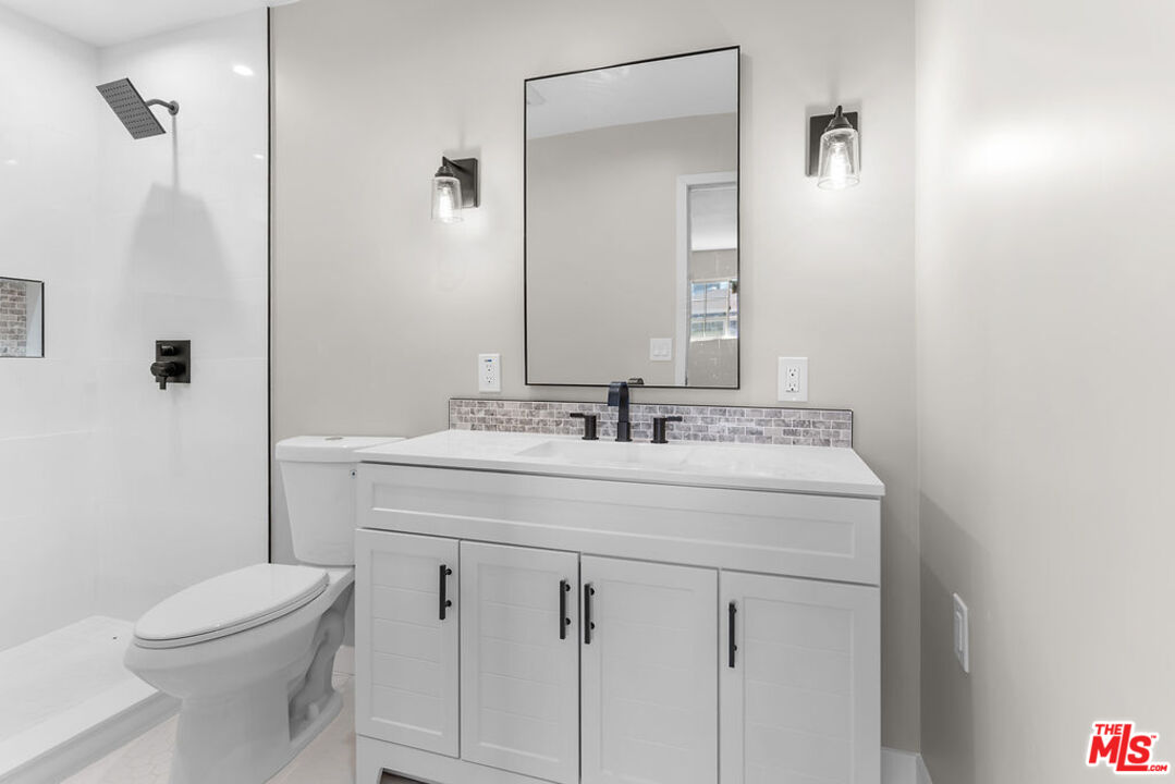 16030 Osage Road Apple Valley, CA 92307 - Photo 23 of 27 a bathroom with a sink a toilet and shower