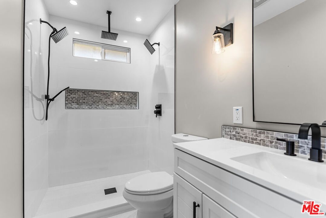 16030 Osage Road Apple Valley, CA 92307 - Photo 24 of 27 a bathroom with a sink a toilet a shower and a mirror