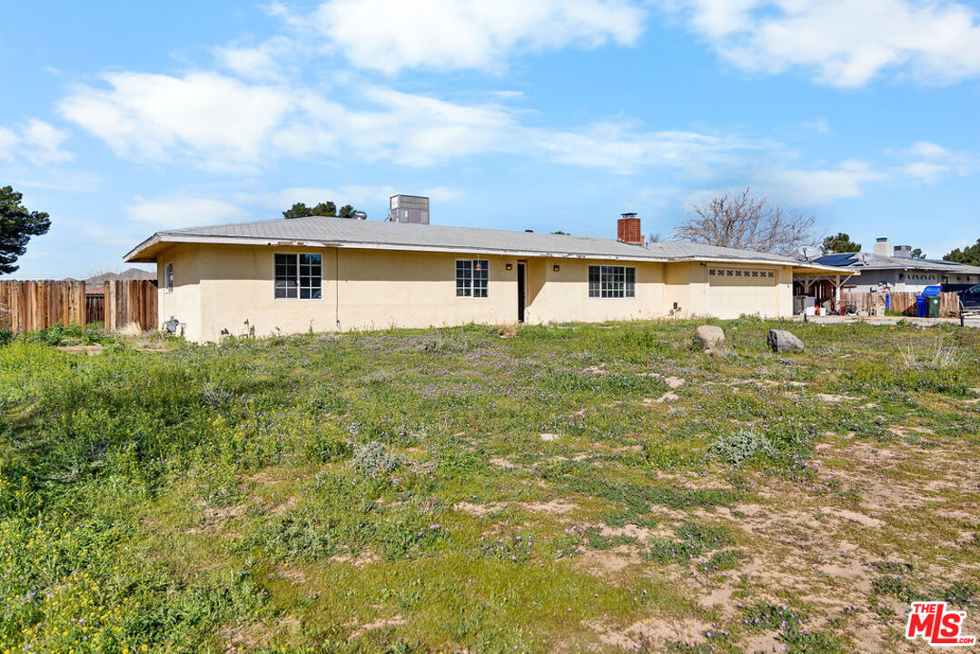 16030 Osage Road Apple Valley, CA 92307 - Photo 4 of 27 a house view with swimming pool and yard in front of it