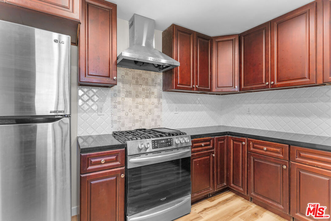 16030 Osage Road Apple Valley, CA 92307 - Photo 10 of 27 a kitchen with stainless steel appliances granite countertop a stove a refrigerator and a cabinets