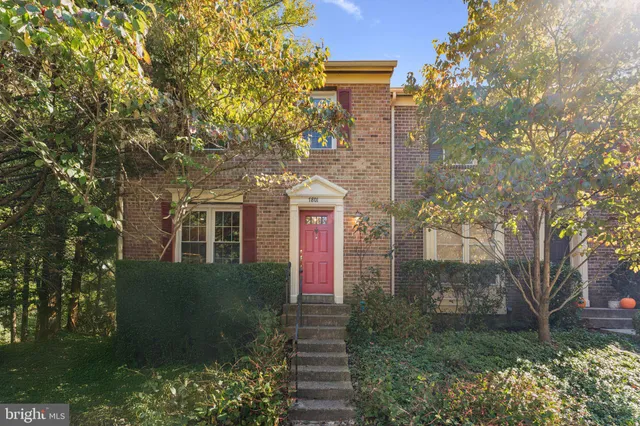 a front view of a house with yard and green space