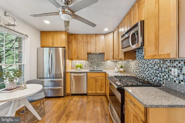 an empty room with fireplace and windows