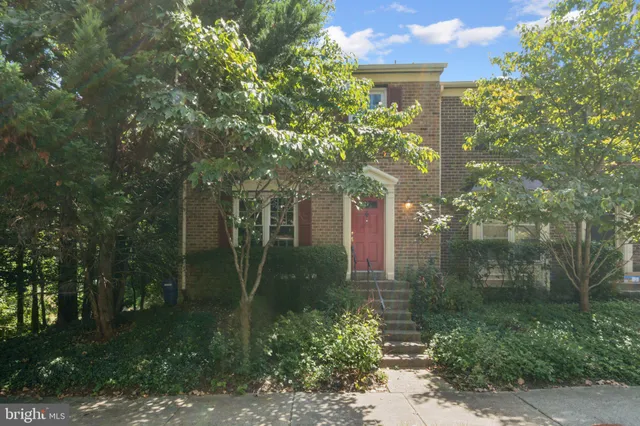 a living room with furniture a fireplace and a table