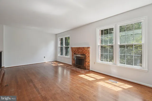 a view of a room with wooden floor