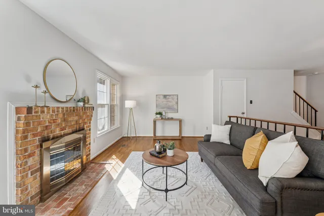 a living room with furniture a fireplace and a window