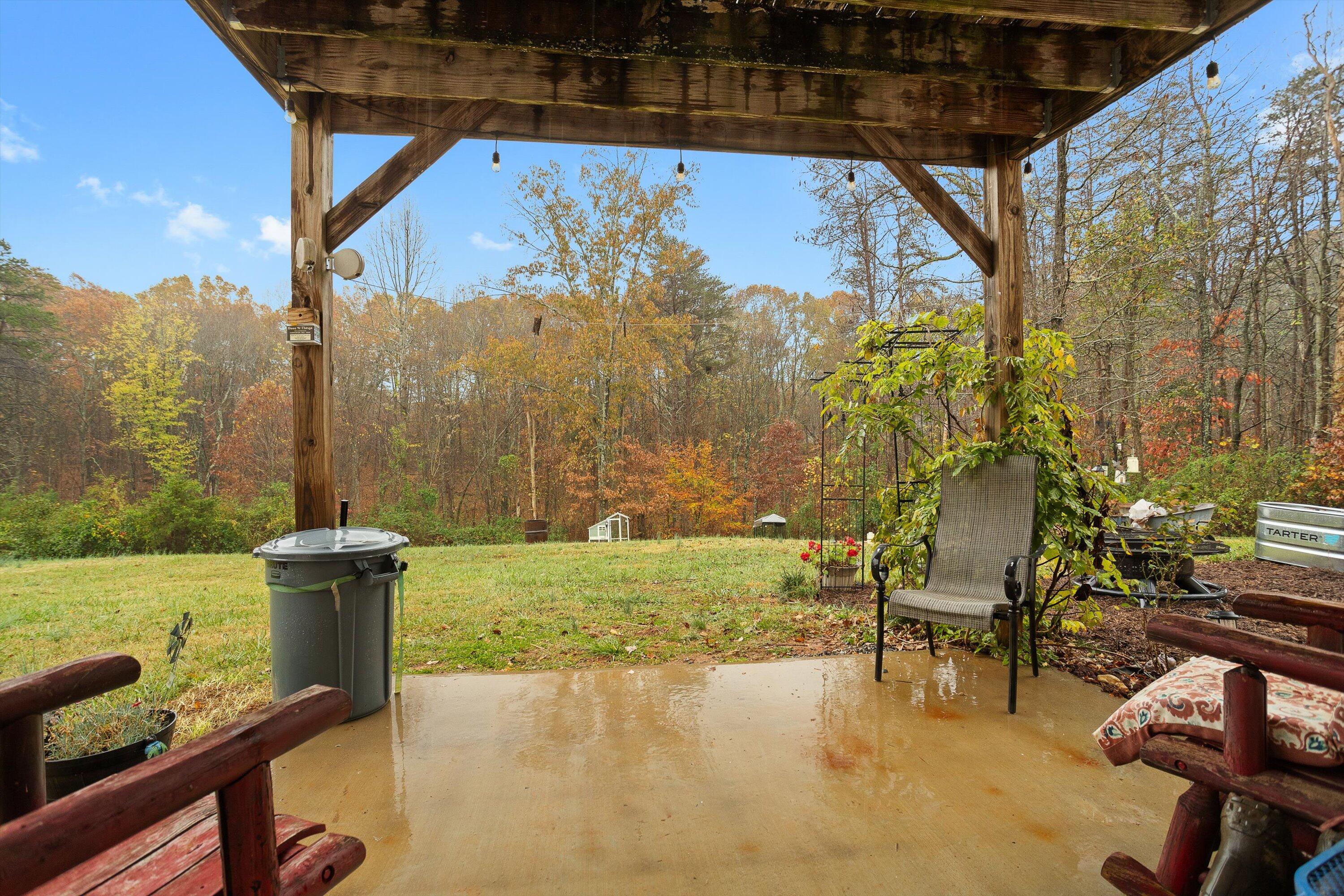4348 Stewartsville Road Moneta, VA 24121 - Photo 23 of 29 a view of a patio with a table chairs and a swimming pool