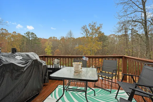 a view of a balcony with mountain view and wooden floor