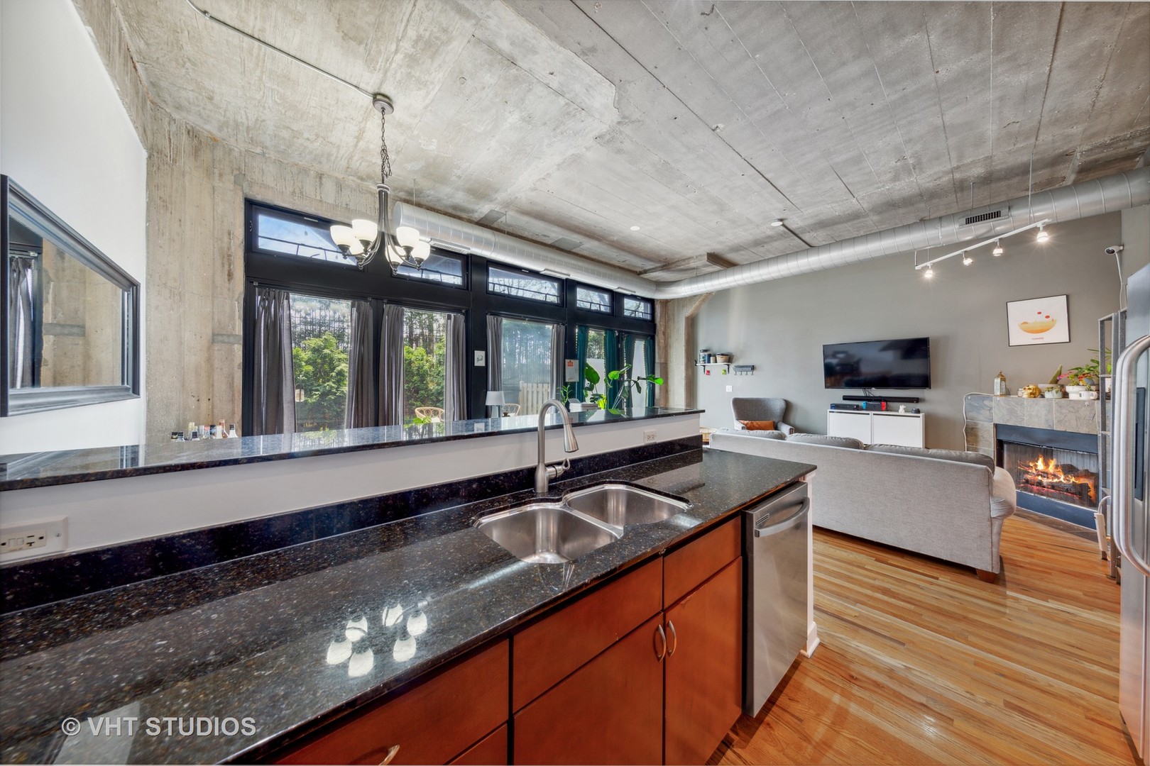 1111 West 15th Street, Unit 115 Chicago, IL 60608 - Photo 11 of 22 a kitchen with stainless steel appliances granite countertop a sink and a wooden floors