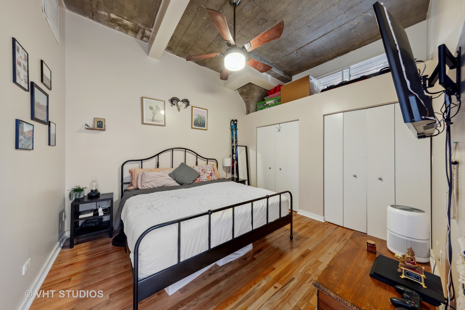 1111 West 15th Street, Unit 115 Chicago, IL 60608 - Photo 14 of 22 a bedroom with a bed and a flat screen tv
