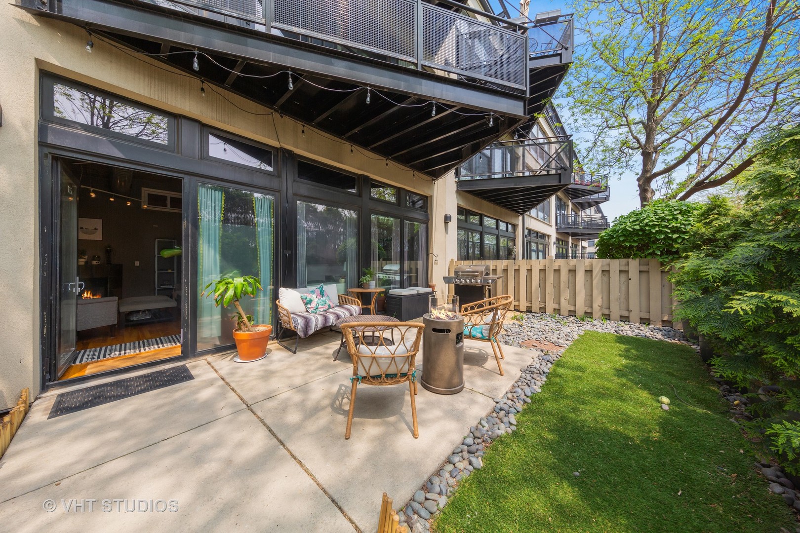 1111 West 15th Street, Unit 115 Chicago, IL 60608 - Photo 3 of 22 a view of a patio with table and chairs and potted plants
